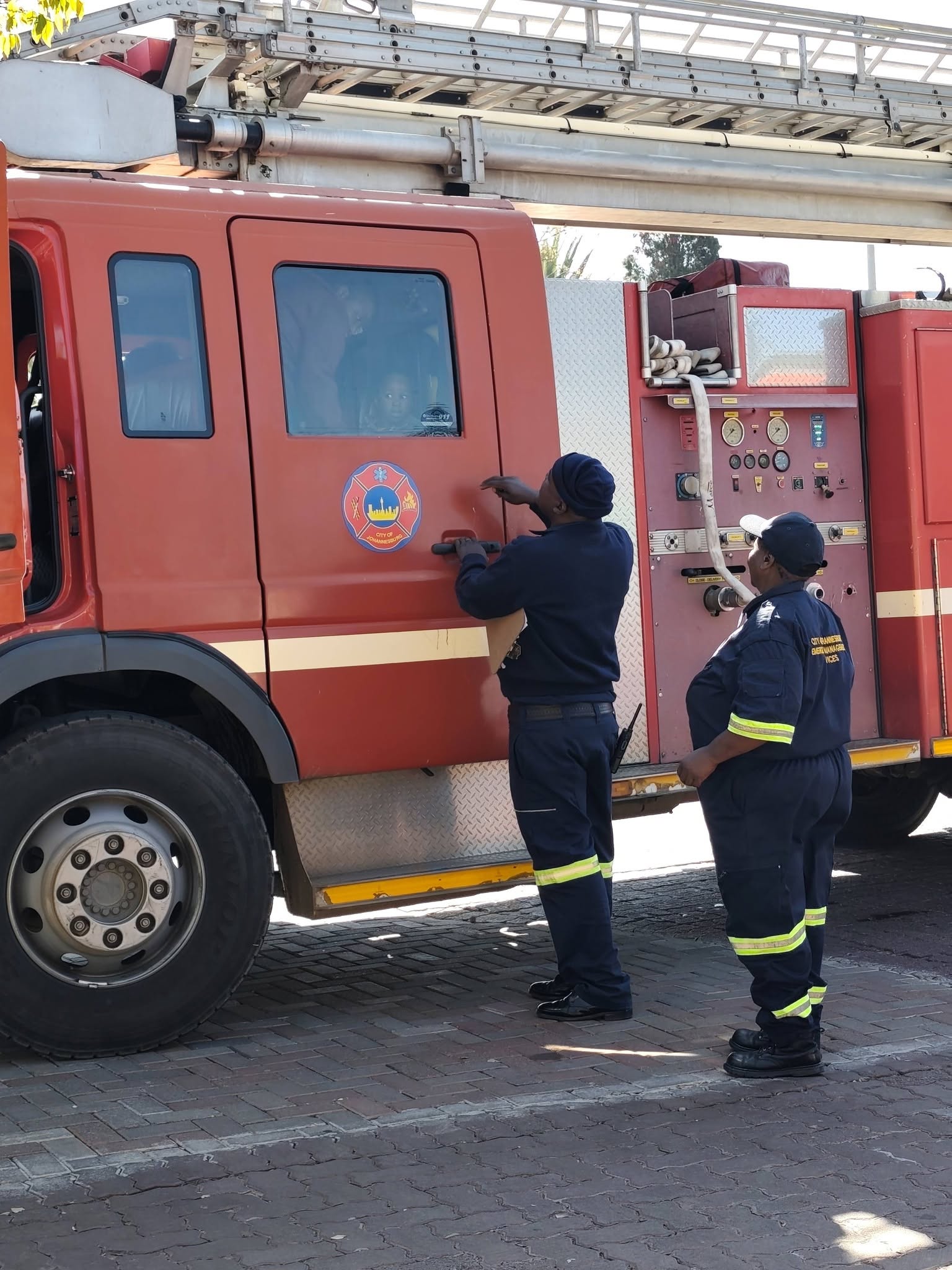 Children learning from firefighters